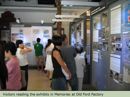 Visitors reading the exhibits in Memories at Old Ford Factory